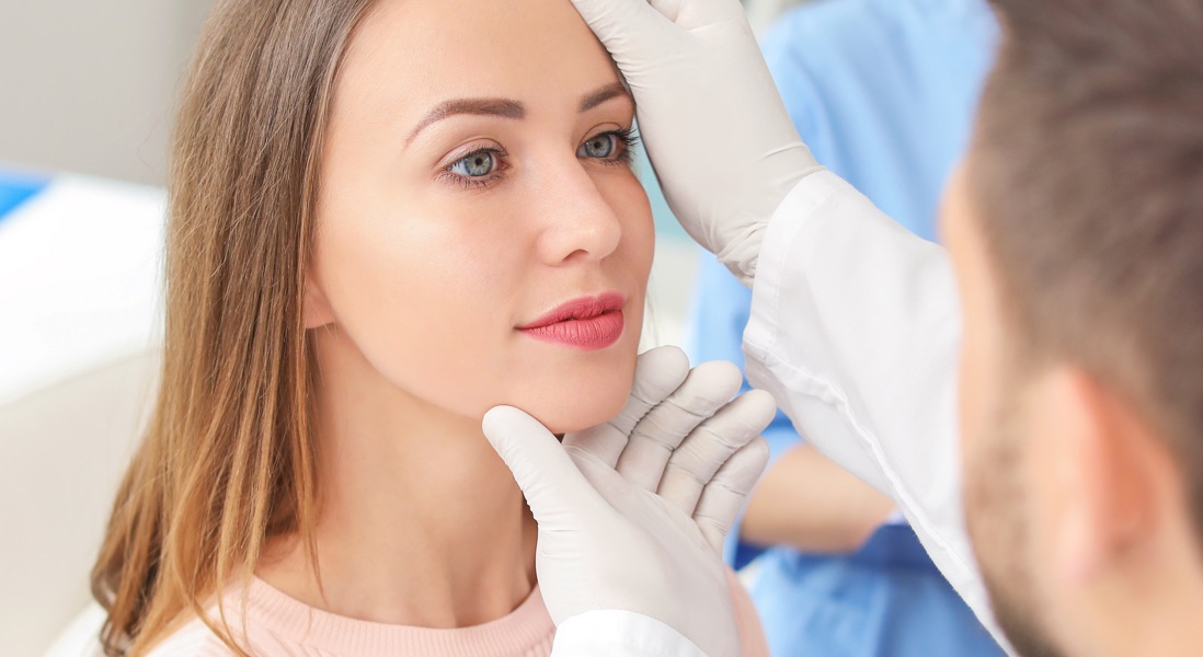 Close up of doctor studying woman's face